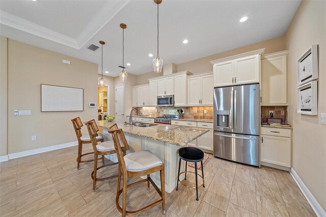 9220 43rd Ter W, Bradenton, FL 34209 - kitchen featuring appliances with stainless steel finishes, a sink, tasteful backsplash, a kitchen bar, and recessed lighting