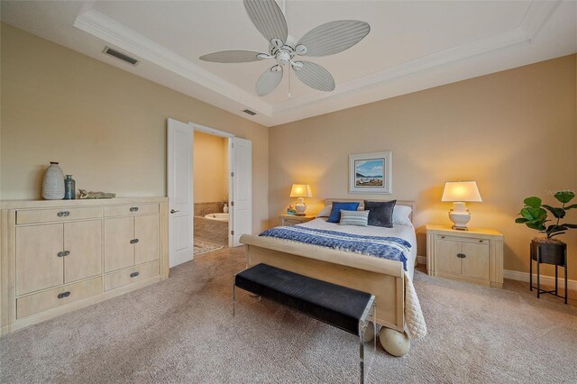 9220 43rd Ter W, Bradenton, FL 34209 - carpeted bedroom with a tray ceiling, ornamental molding, connected bathroom, and ceiling fan