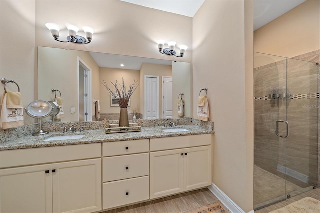 9220 43rd Ter W, Bradenton, FL 34209 - full bathroom featuring a shower stall, double vanity, and wood finished floors