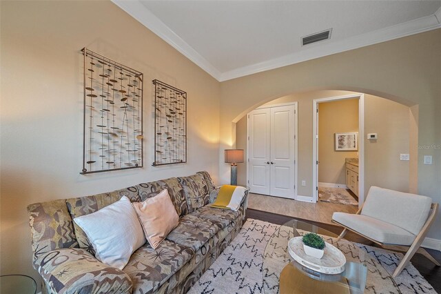 9220 43rd Ter W, Bradenton, FL 34209 - living area with arched walkways, crown molding, wood finished floors, and baseboards