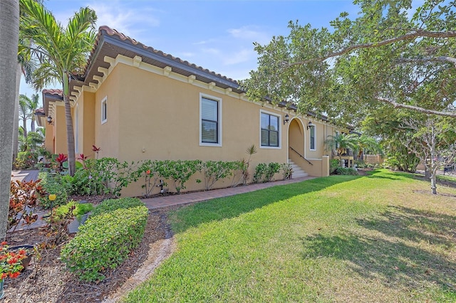9220 43rd Ter W, Bradenton, FL 34209 - view of side of home featuring stucco siding and a lawn