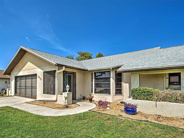 5832 Monroe Rd, Venice, FL 34293 - single story home featuring a garage, concrete driveway, a front lawn, and roof with shingles