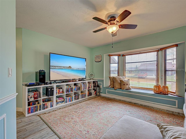5832 Monroe Rd, Venice, FL 34293 - living area with ceiling fan, wood finished floors, a textured ceiling, and baseboards