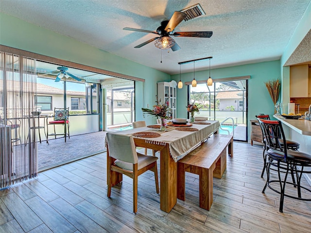 5832 Monroe Rd, Venice, FL 34293 - dining room featuring ceiling fan, a textured ceiling, and light wood-type flooring