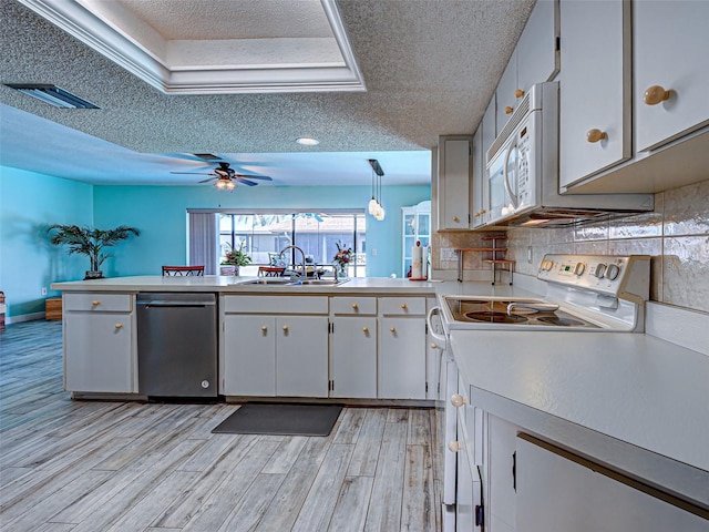 5832 Monroe Rd, Venice, FL 34293 - kitchen featuring white appliances, a sink, a textured ceiling, light countertops, and light wood finished floors