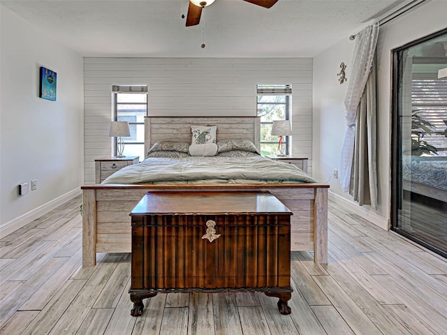 5832 Monroe Rd, Venice, FL 34293 - bedroom featuring light wood-type flooring, baseboards, a ceiling fan, and wood walls