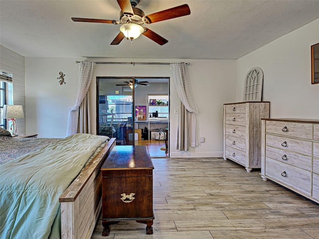 5832 Monroe Rd, Venice, FL 34293 - bedroom featuring multiple windows, wood finished floors, a textured ceiling, and a ceiling fan