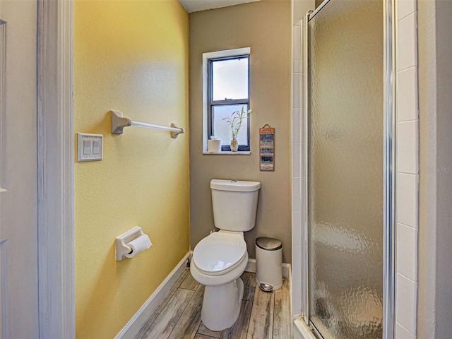 5832 Monroe Rd, Venice, FL 34293 - bathroom with toilet, a shower stall, wood finished floors, and baseboards
