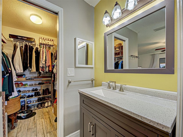 5832 Monroe Rd, Venice, FL 34293 - bathroom with vanity, hardwood / wood-style flooring, and a walk in closet