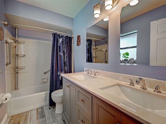 5832 Monroe Rd, Venice, FL 34293 - bathroom with shower / tub combo with curtain, toilet, wood finished floors, double vanity, and a textured ceiling