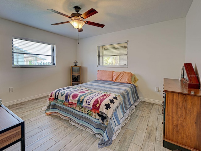 5832 Monroe Rd, Venice, FL 34293 - bedroom with light wood-type flooring, baseboards, and a ceiling fan