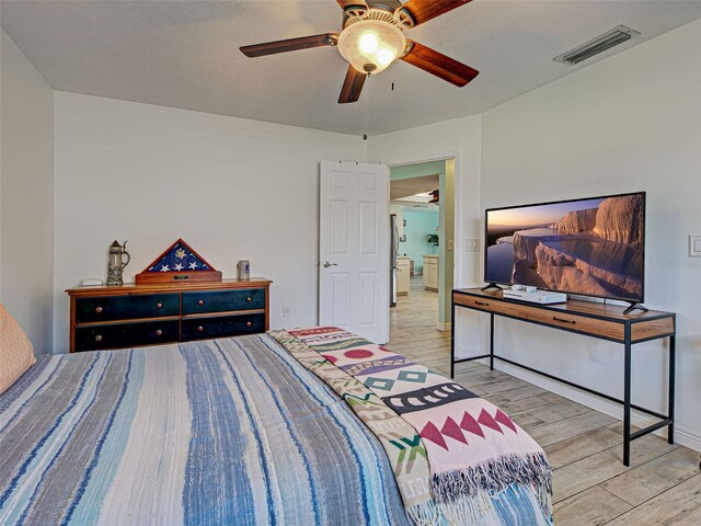 5832 Monroe Rd, Venice, FL 34293 - bedroom with wood finished floors and a ceiling fan