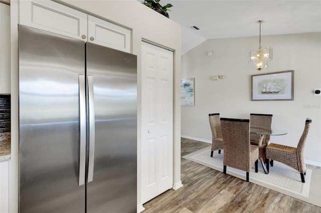 25509 Arequipa Dr, Punta Gorda, FL 33983 - dining space with light wood-type flooring, lofted ceiling, baseboards, and a chandelier