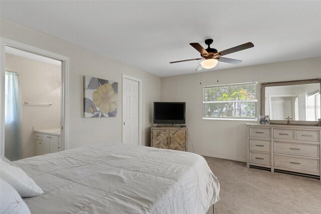 25509 Arequipa Dr, Punta Gorda, FL 33983 - carpeted bedroom with ensuite bath, baseboards, and a ceiling fan