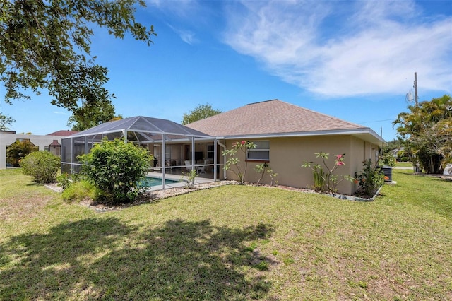 25509 Arequipa Dr, Punta Gorda, FL 33983 - back of house with a lawn, stucco siding, an outdoor pool, a lanai, and a shingled roof