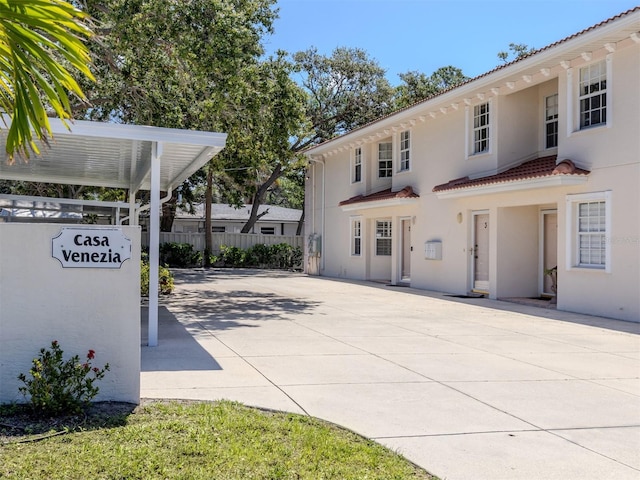 528 W Venice Ave Unit 1, Venice, FL 34285 - view of front facade featuring fence, a tiled roof, stucco siding, and a patio