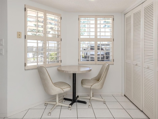 528 W Venice Ave Unit 1, Venice, FL 34285 - dining space featuring baseboards, plenty of natural light, and light tile patterned floors