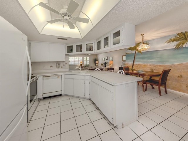 528 W Venice Ave Unit 1, Venice, FL 34285 - kitchen with white appliances, a sink, light countertops, a peninsula, and light tile patterned floors