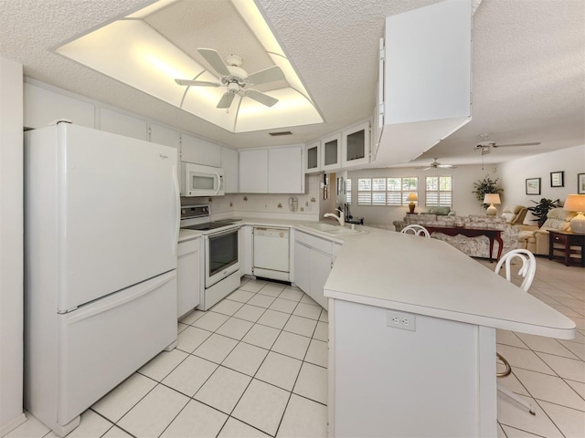 528 W Venice Ave Unit 1, Venice, FL 34285 - kitchen with white appliances, ceiling fan, a peninsula, light tile patterned floors, and open floor plan