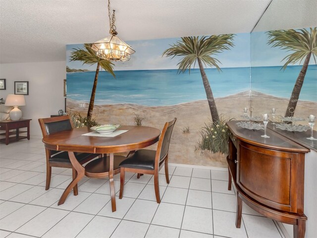 528 W Venice Ave Unit 1, Venice, FL 34285 - dining area with a textured ceiling, a chandelier, and light tile patterned floors