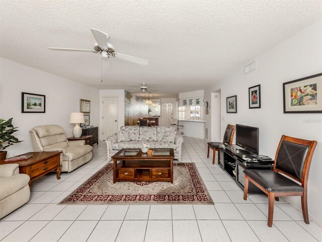 528 W Venice Ave Unit 1, Venice, FL 34285 - living room featuring a ceiling fan, light tile patterned floors, and a textured ceiling
