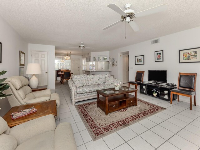 528 W Venice Ave Unit 1, Venice, FL 34285 - living room with a ceiling fan, light tile patterned floors, and a textured ceiling