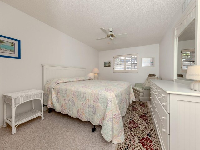 528 W Venice Ave Unit 1, Venice, FL 34285 - bedroom featuring light carpet, a textured ceiling, and a ceiling fan