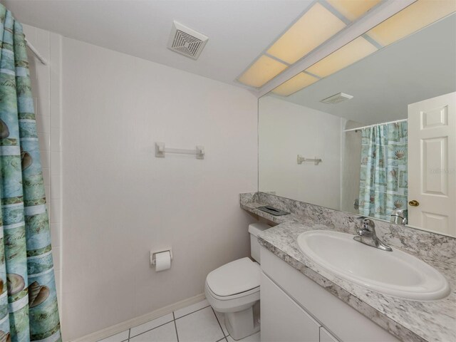 528 W Venice Ave Unit 1, Venice, FL 34285 - full bath featuring tile patterned flooring, toilet, a shower with shower curtain, vanity, and baseboards