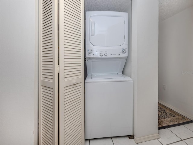 528 W Venice Ave Unit 1, Venice, FL 34285 - washroom featuring stacked washing machine and dryer and light tile patterned floors