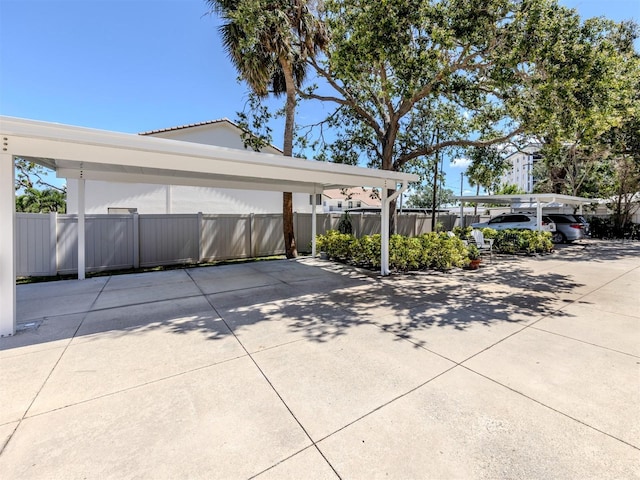 528 W Venice Ave Unit 1, Venice, FL 34285 - view of parking / parking lot featuring fence and a detached carport