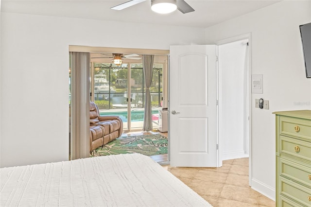 bedroom with access to exterior, light tile patterned floors, and ceiling fan