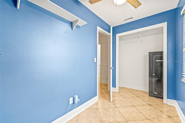 unfurnished bedroom featuring baseboards, a closet, ceiling fan, and tile patterned flooring
