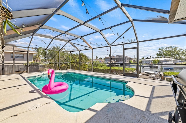 outdoor pool featuring a patio area and glass enclosure