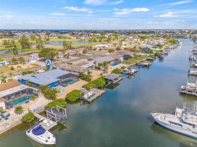 aerial view of residential area featuring a large body of water