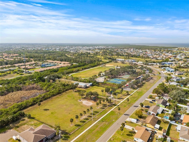aerial view of property and surrounding area featuring nearby suburban area