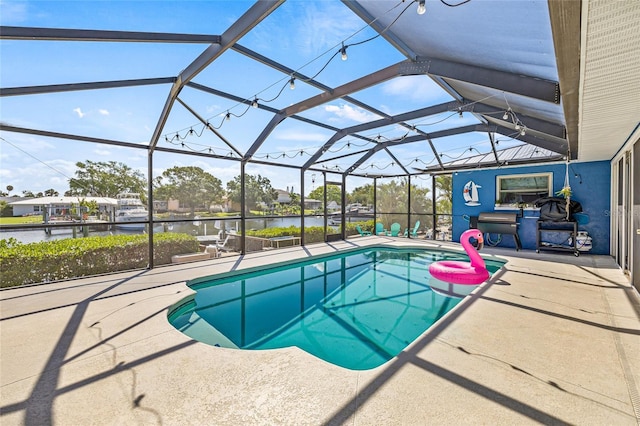 swimming pool featuring a patio area, a water view, and glass enclosure