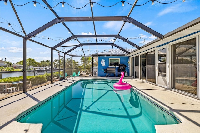 swimming pool featuring a patio, a water view, and a lanai