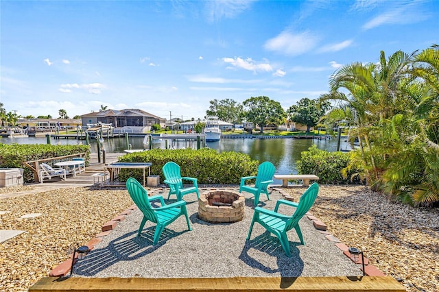 view of patio / terrace with a fire pit, a water view, and a boat dock