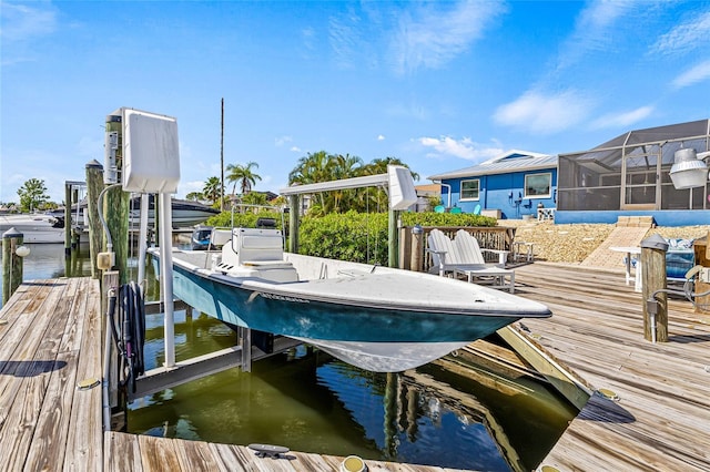 dock area with boat lift and a water view