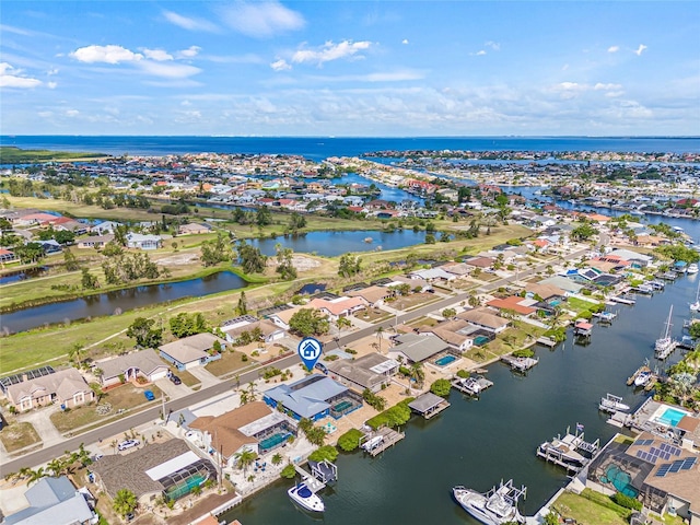 aerial overview of property's location featuring a nearby body of water and nearby suburban area