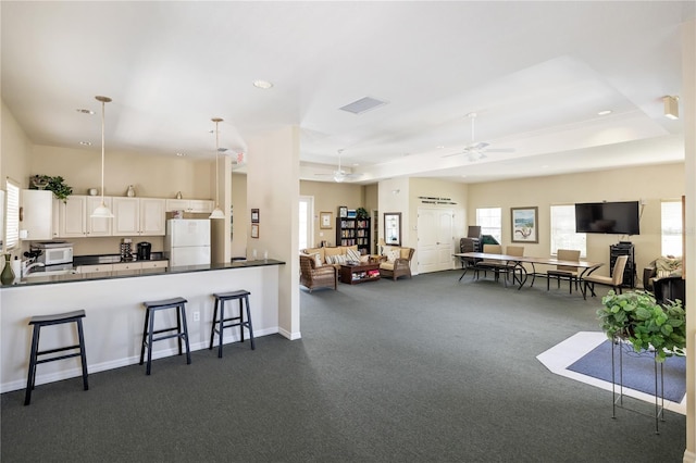 600 Gardens Edge Dr Unit 613, Venice, FL 34285 - kitchen featuring freestanding refrigerator, dark countertops, a breakfast bar, a ceiling fan, and recessed lighting