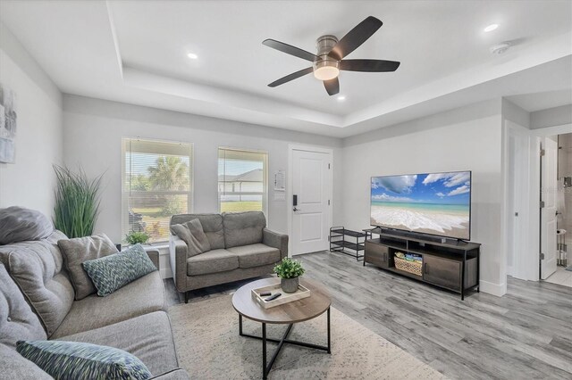 12031 Saragossa Ln, North Port, FL 34287 - living area with a raised ceiling, wood finished floors, ceiling fan, recessed lighting, and baseboards
