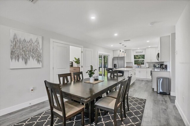 12031 Saragossa Ln, North Port, FL 34287 - dining area with light wood-style flooring, baseboards, and recessed lighting
