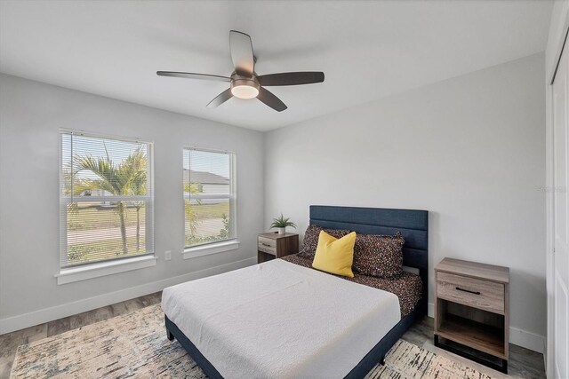 12031 Saragossa Ln, North Port, FL 34287 - bedroom with baseboards, wood finished floors, and a ceiling fan