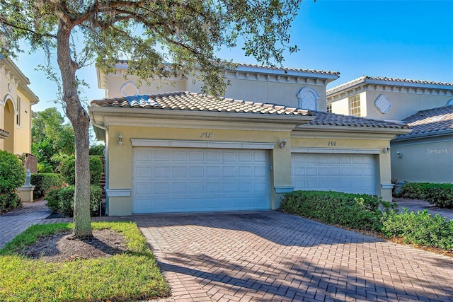 212 Triano Cir Unit 212, Venice, FL 34292 - view of front of property with stucco siding, decorative driveway, and a tile roof