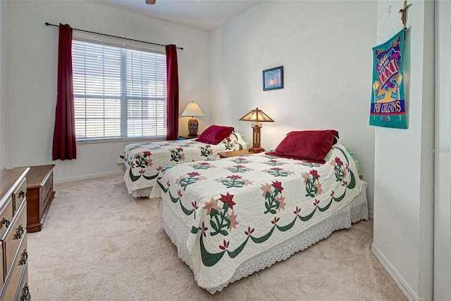 212 Triano Cir Unit 212, Venice, FL 34292 - bedroom with light colored carpet, baseboards, and a ceiling fan