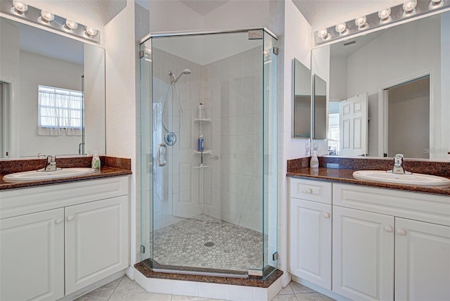 212 Triano Cir Unit 212, Venice, FL 34292 - full bath featuring a shower stall, two vanities, and tile patterned flooring