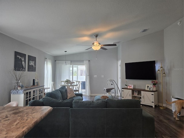 3003 58th Way E, Palmetto, FL 34221 - living area with dark wood-style flooring, baseboards, ceiling fan, lofted ceiling, and a textured ceiling