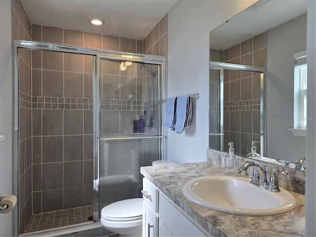 3003 58th Way E, Palmetto, FL 34221 - full bathroom featuring a stall shower, vanity, toilet, and recessed lighting