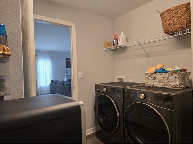 3003 58th Way E, Palmetto, FL 34221 - clothes washing area with washing machine and clothes dryer, dark wood-style flooring, and baseboards